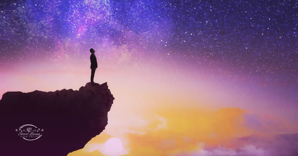 Person standing at cliff's edge under starry sky.