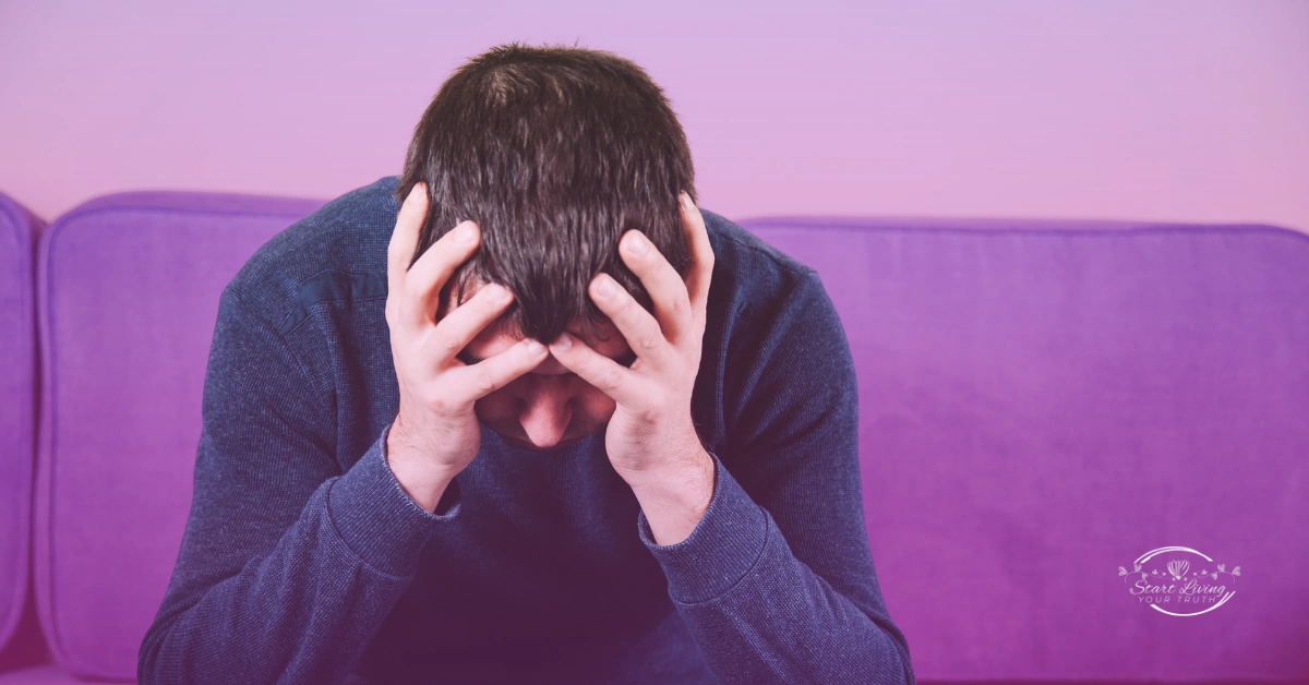 Person in distress holding head with hands.