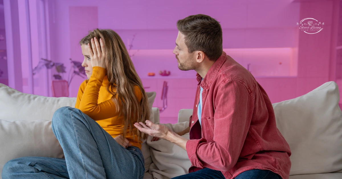 Couple arguing on sofa, emotional discussion at home.