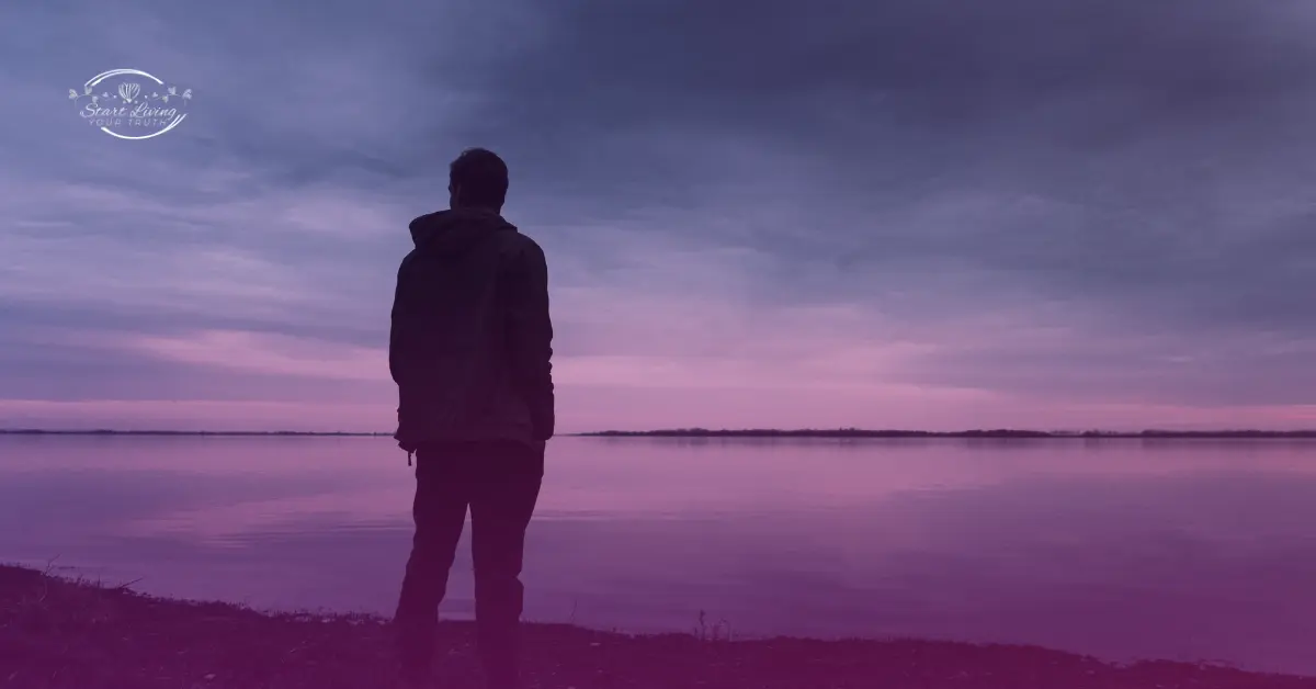 Person watching purple sunset over calm lake.