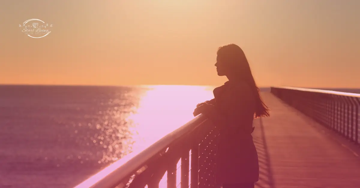 Silhouette of woman enjoying sunset on pier.
