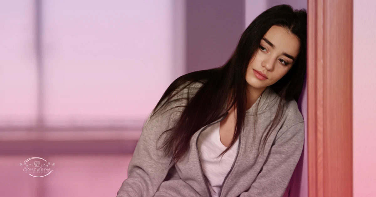 Woman in hoodie looking thoughtful