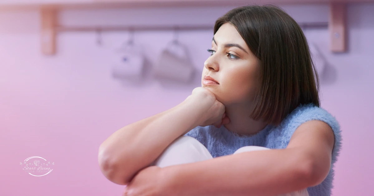 Woman looking thoughtful in pastel room.