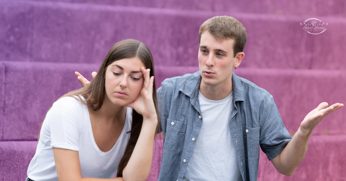 Couple having a serious discussion on purple stairs.