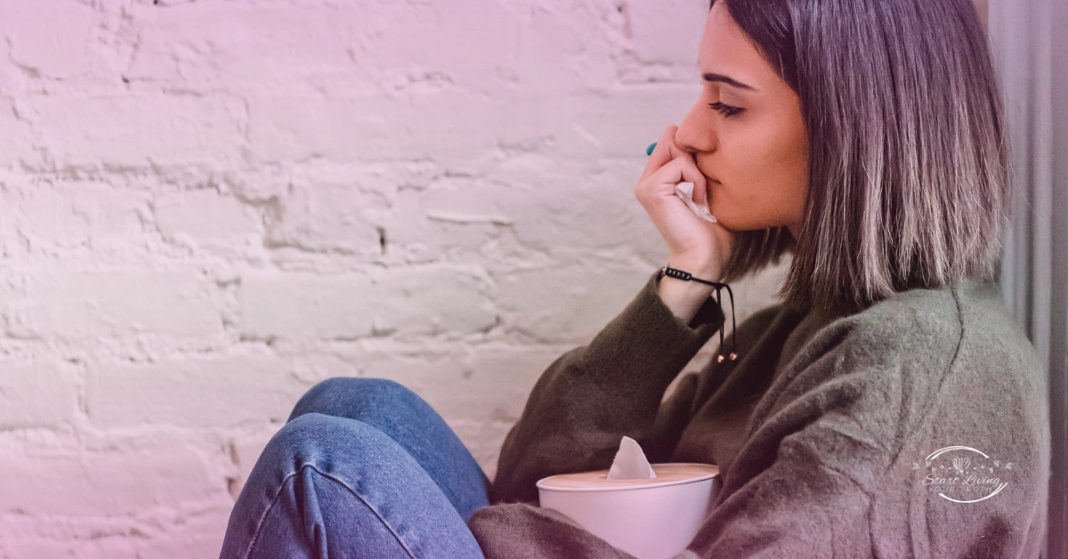 Woman in deep thought holding a tissue