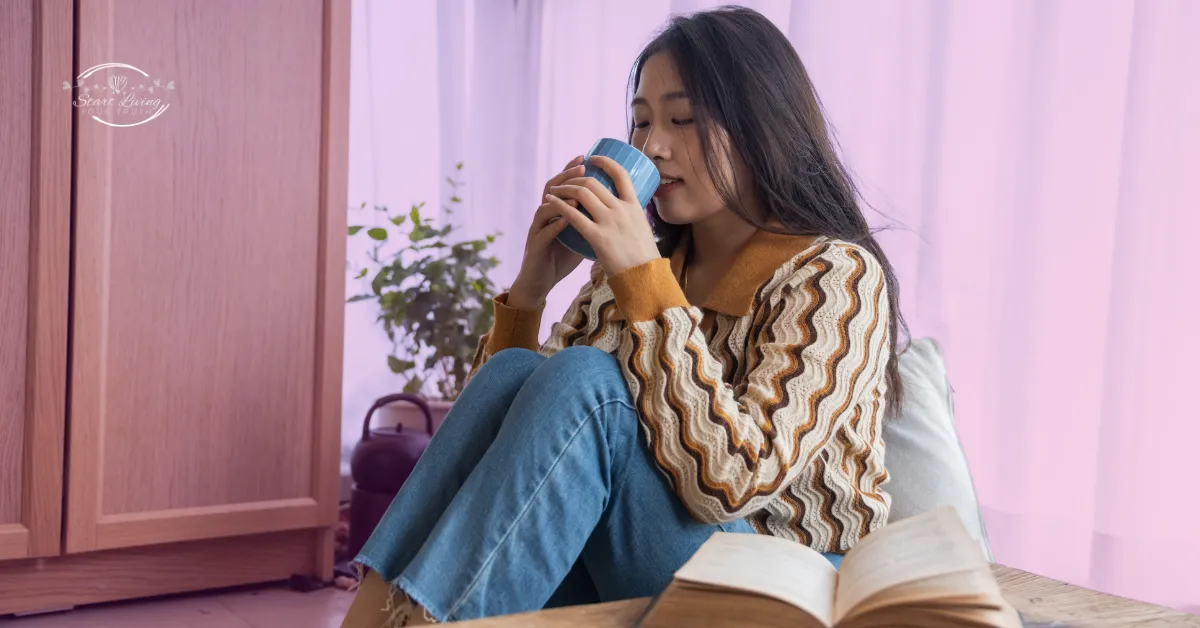 Woman sipping coffee, cosy indoor setting.