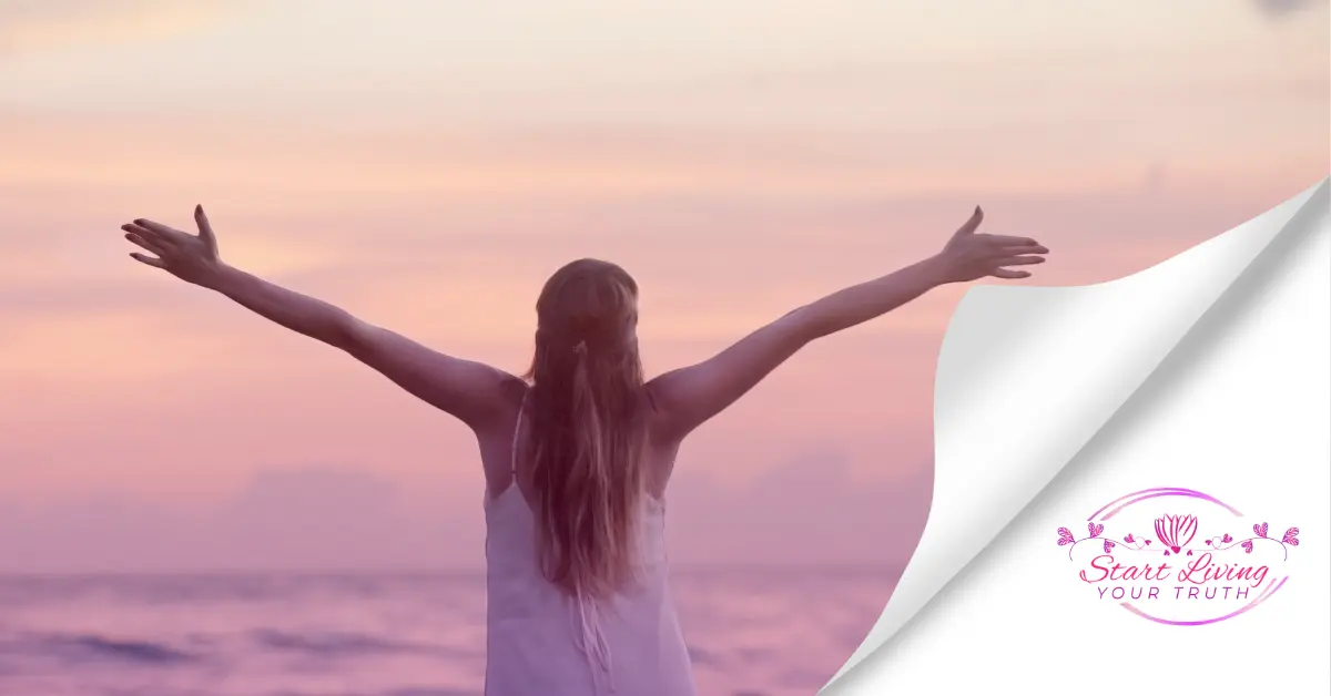 Woman embracing sunrise at the beach